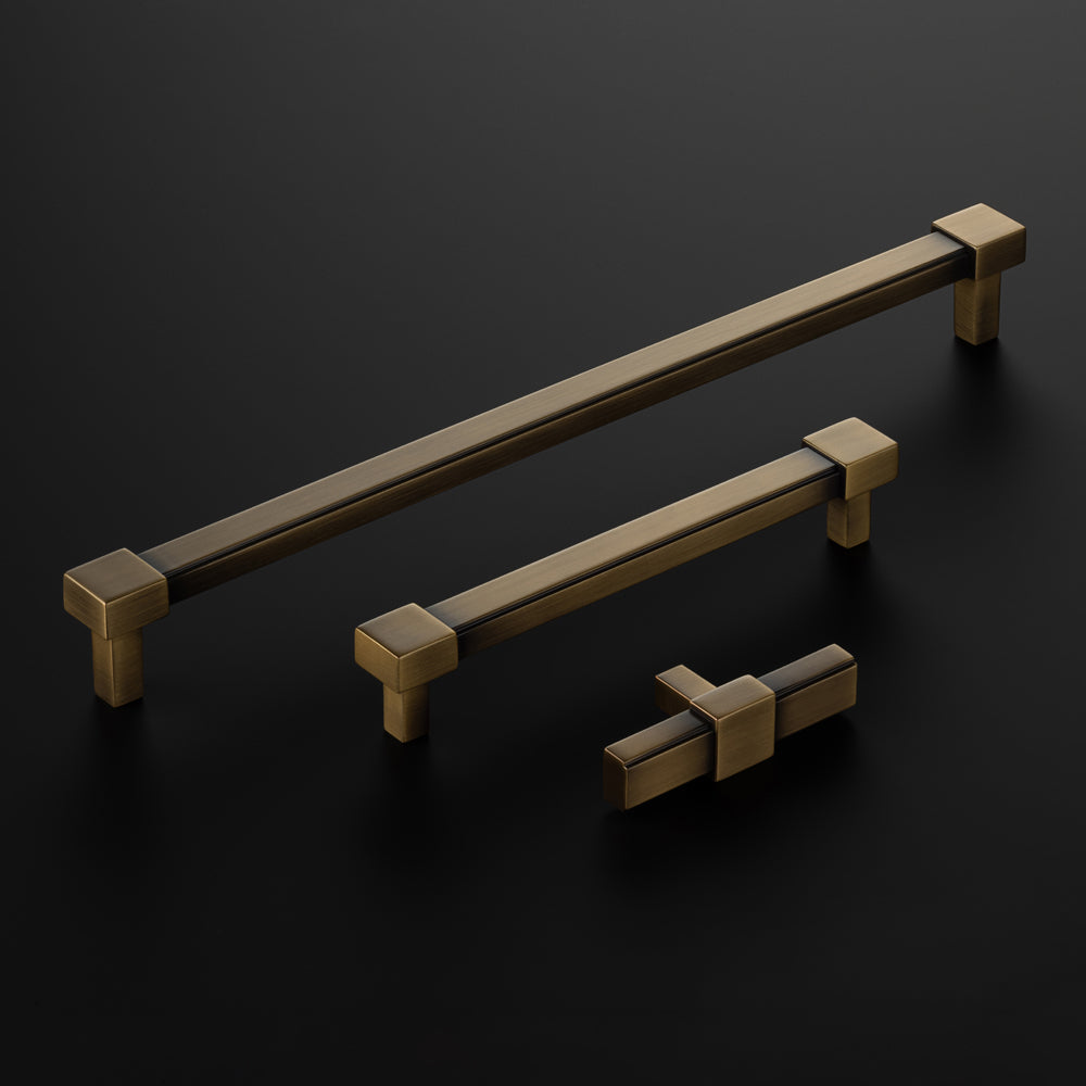Set of bronze cabinet handles on a dark background